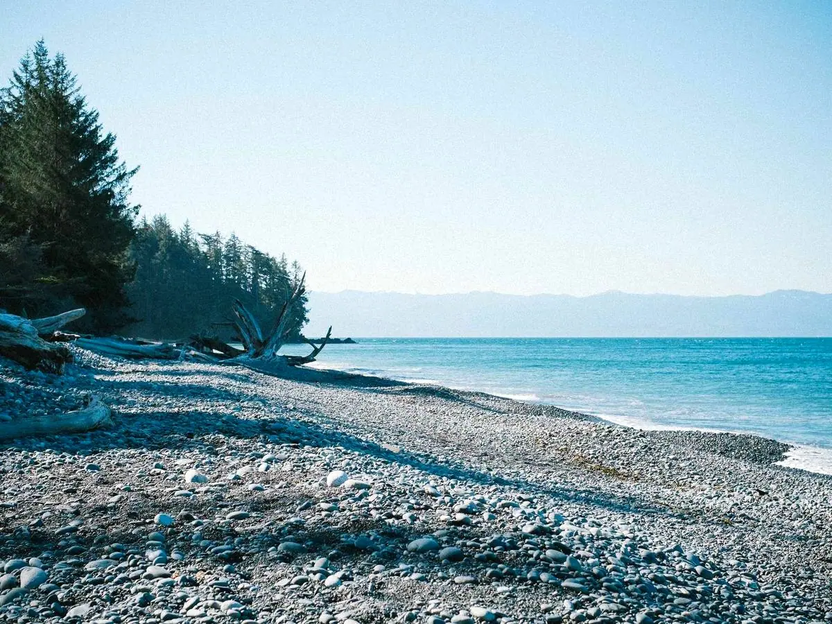 The same beach photograph after 4× AI upscaling, with sharper detail and richer colour